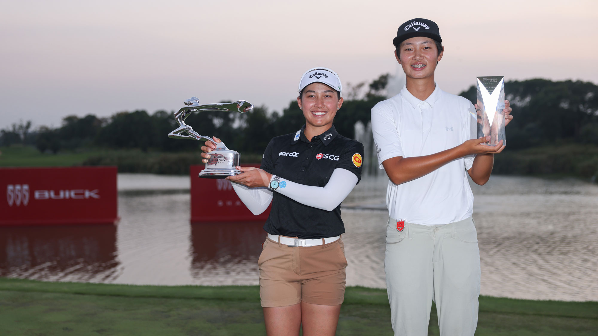 Jeeno Thitikul of Thailand and the Best Amateur Ying Xu of China pose with their trophy during the award ceremony after winning the final round of the Buick LPGA Shanghai 2025 at hanghai Qizhong Garden Golf Club on October 12, 2025 in Shanghai, China.