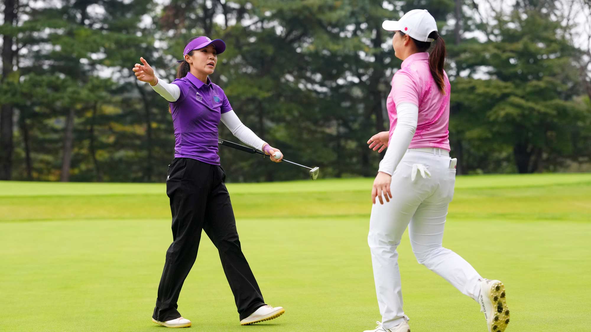 Lydia Ko of the World Team embraces Rio Takeda of Japan Team