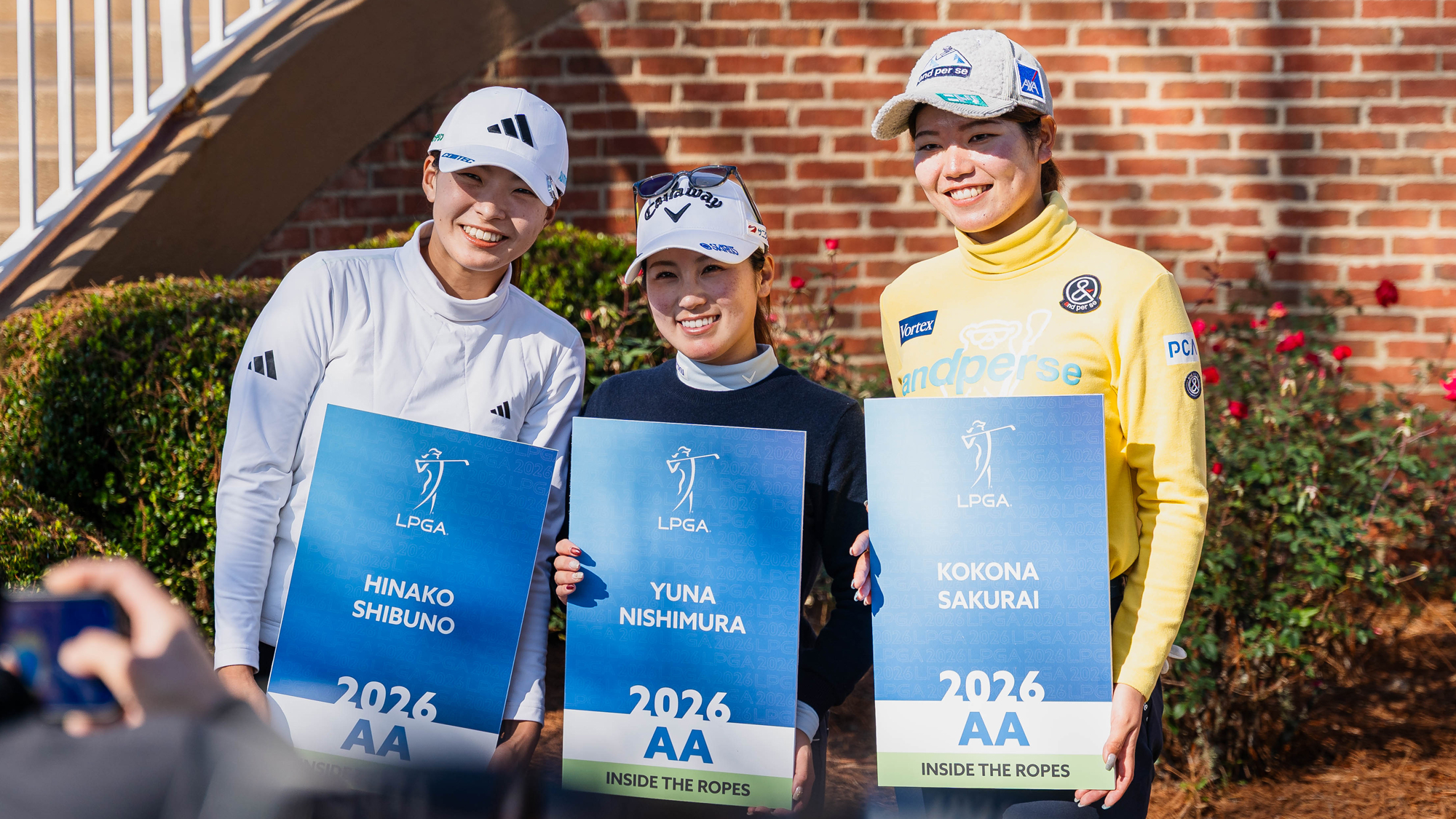Hinako Shibuno, Yuna Nishimura, and Kokona Sakurai stand with their cards during the LPGA Card Ceremony after the final round of 2025 LPGA Q-Series: Final Qualifying Stage at RTJ at Magnolia Grove on December 9, 2025 in Mobile, Alabama.